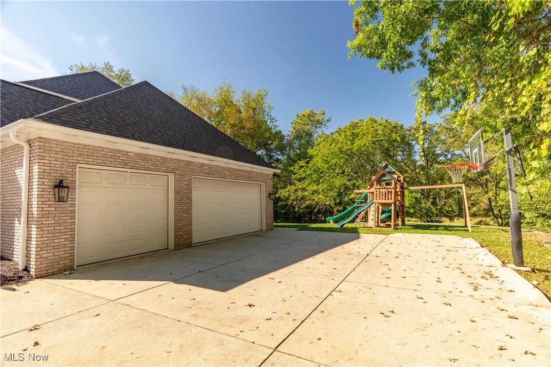 Side entrance 3 car garage and basketball hoop which conveys with the home.