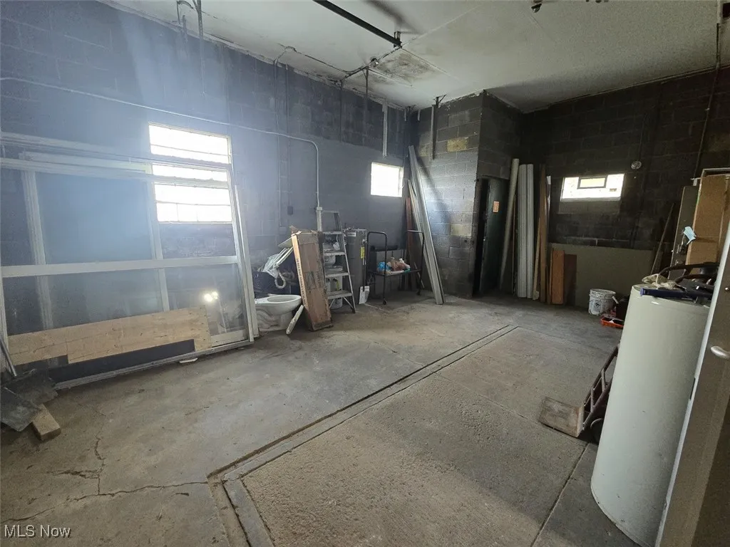 Garage featuring concrete block wall