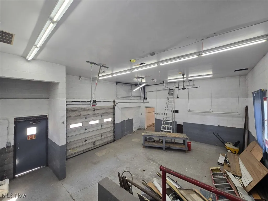 Garage featuring concrete block wall