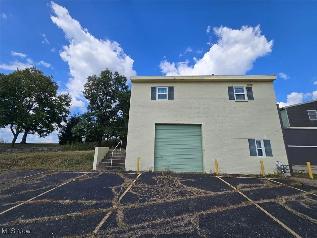 Side of property with brick siding and stairs