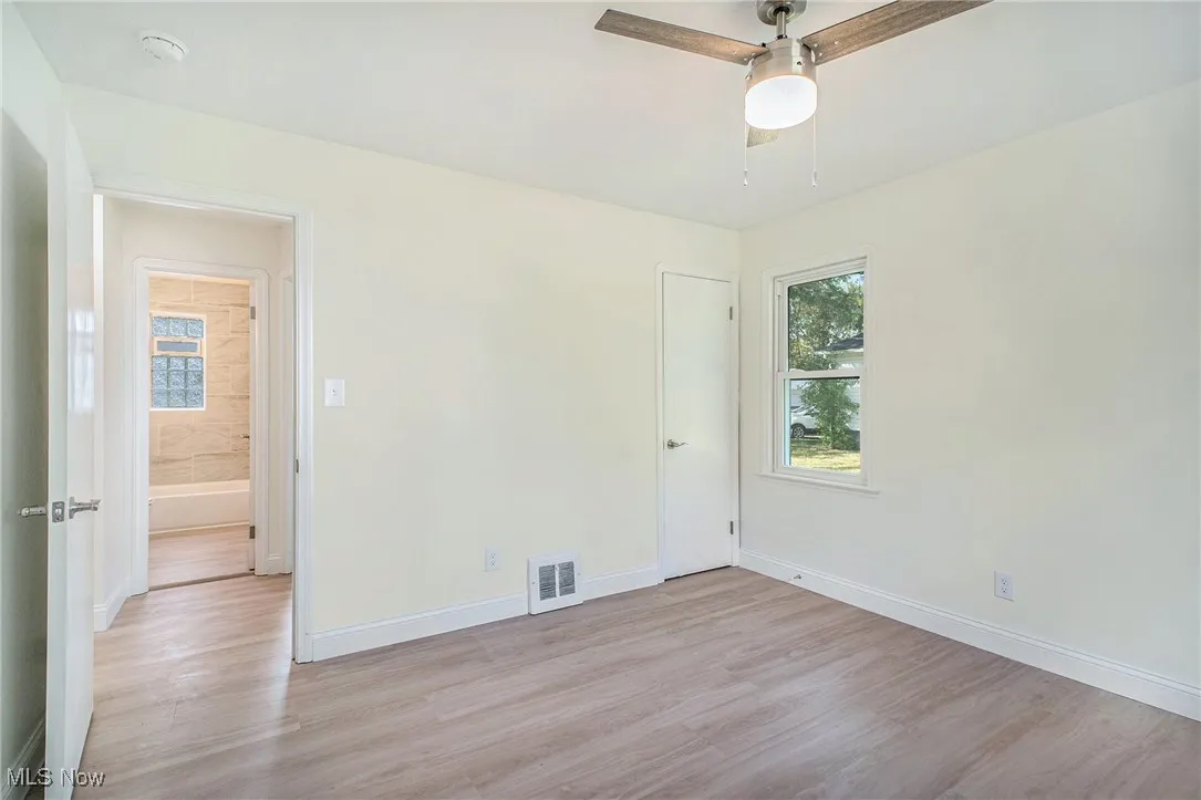 Spare room featuring light wood-style flooring and a ceiling fan