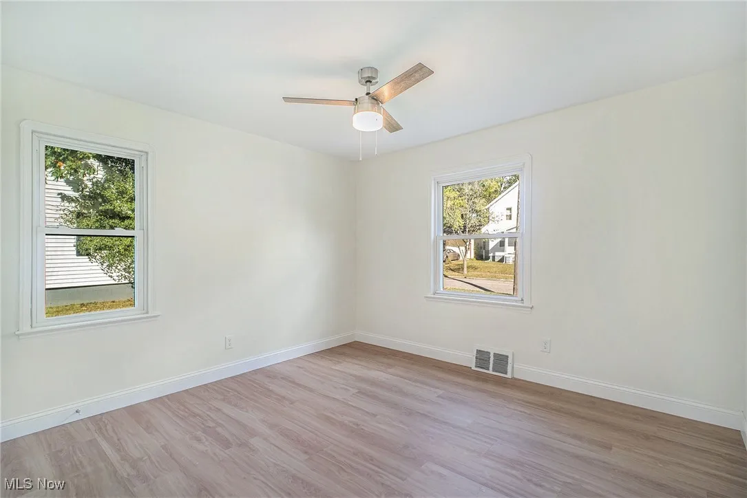Spare room with light wood-style floors and ceiling fan