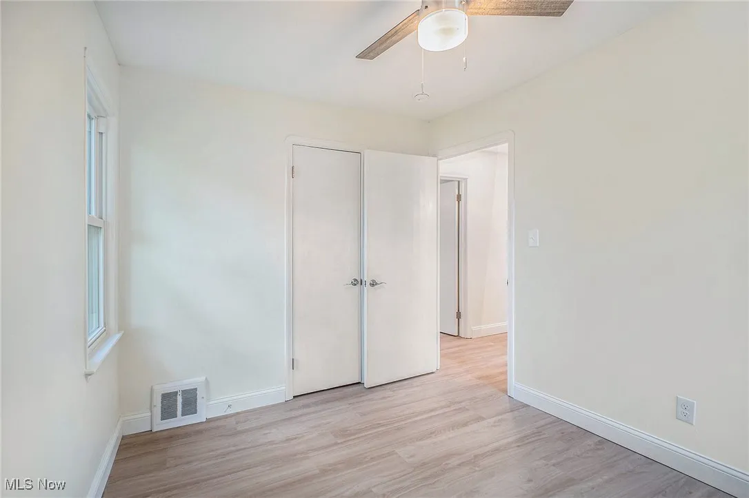 Unfurnished bedroom featuring light wood-style flooring and a ceiling fan