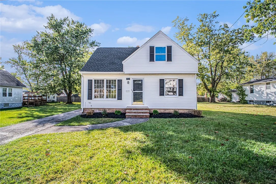 View of front of house with a shingled roof and entry steps