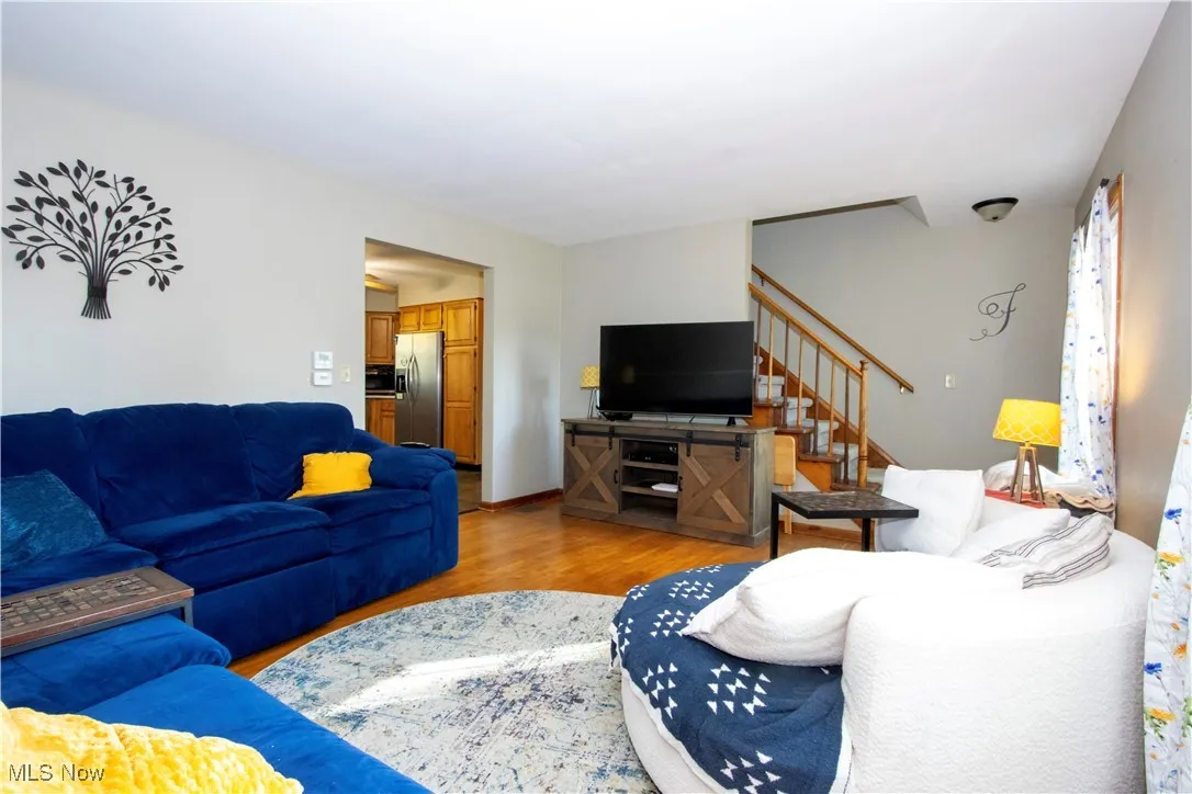Living area featuring wood finished floors and stairs
