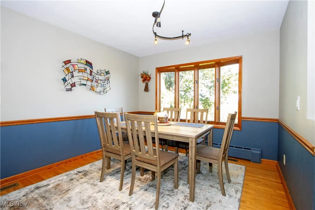 Dining space featuring light wood-type flooring and baseboard heating