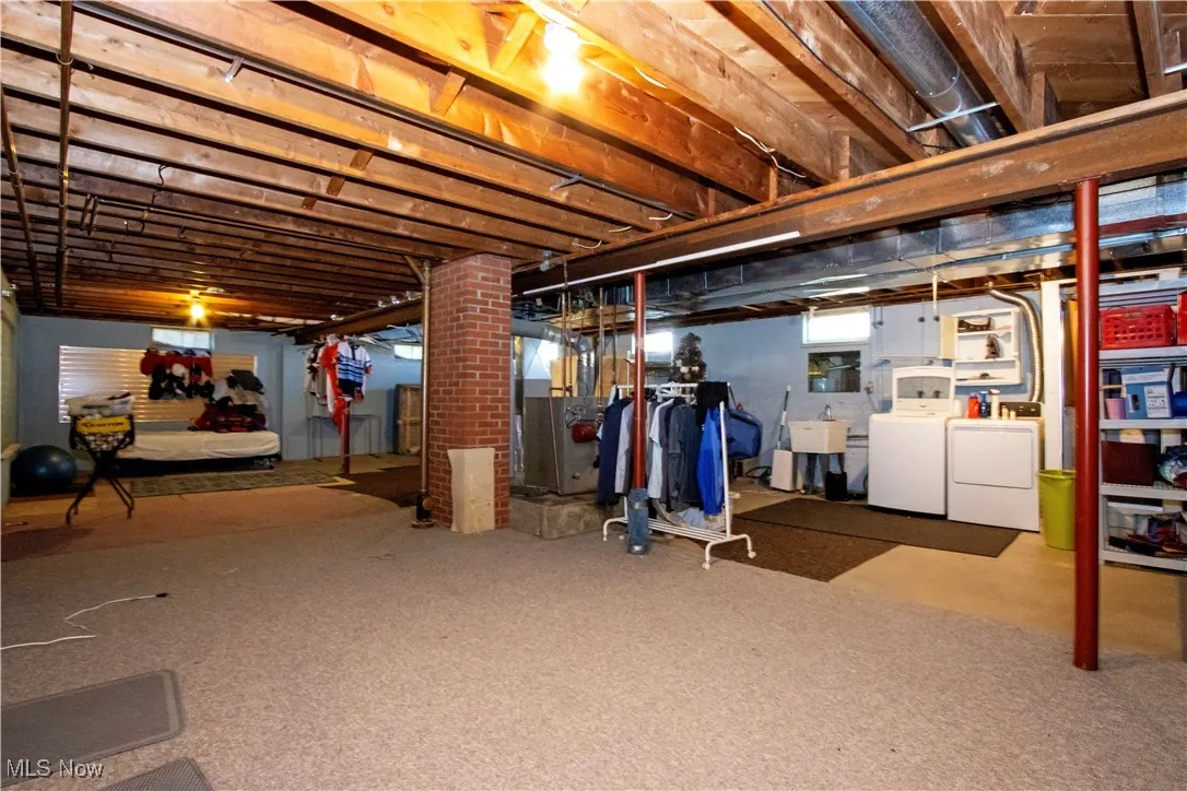 Below grade area with separate washer and dryer and a sink