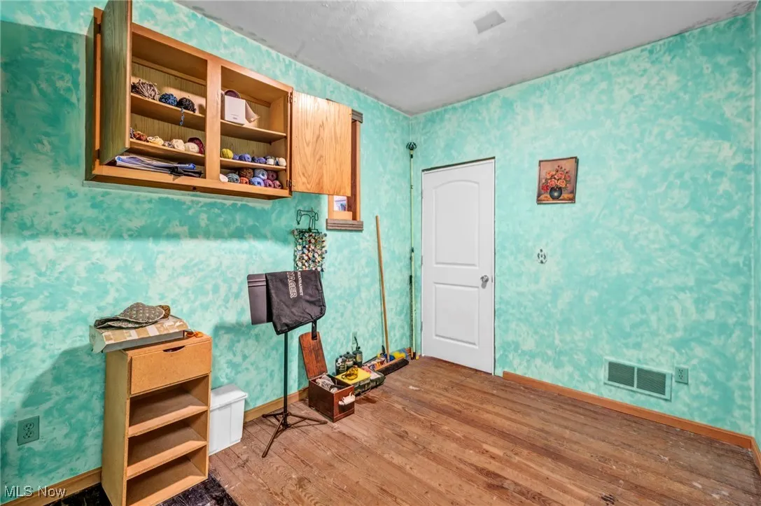 First bedroom to the right walking down the hallway. Hardwood floors / connecting closets / painted walls