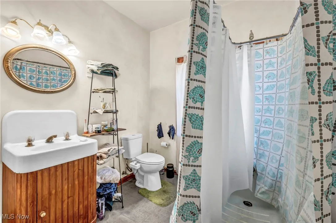 Full bathroom featuring a shower / tub / toilet and original sink with custom made cabinet