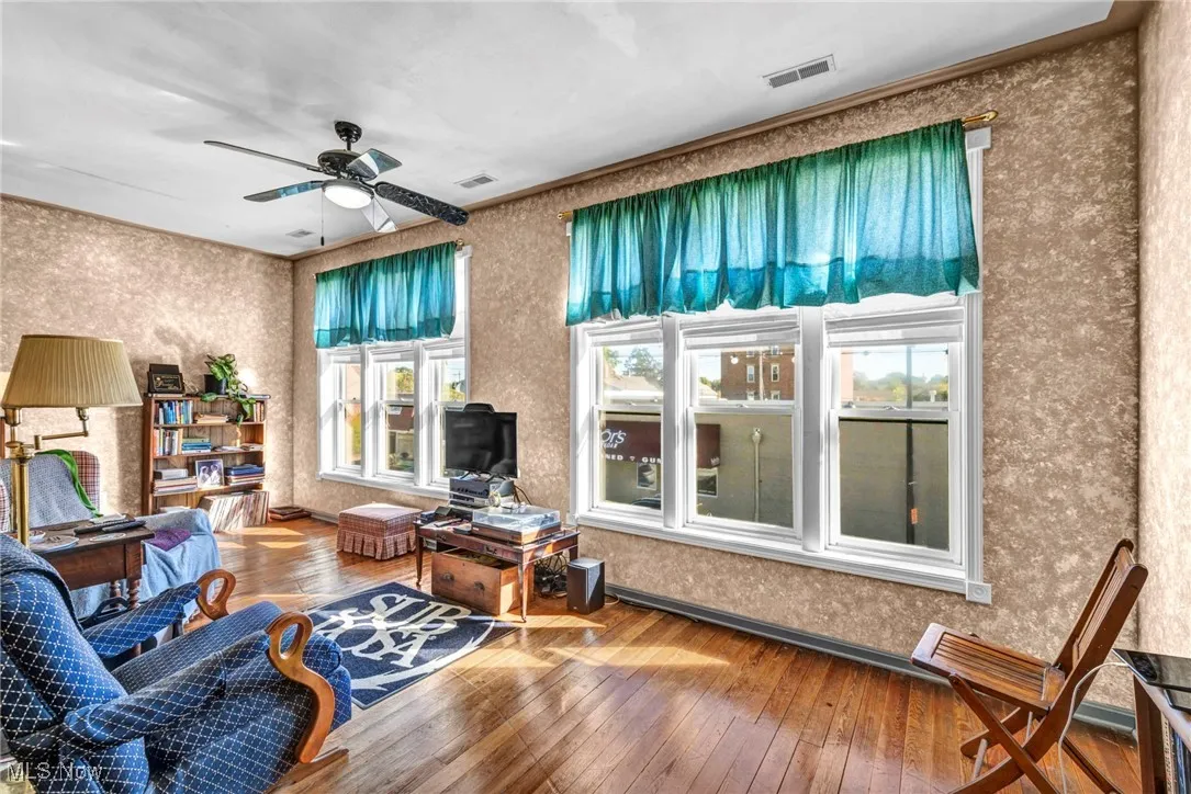 Living area featuring hardwood / recessed lighting, attic access, and ceiling fan