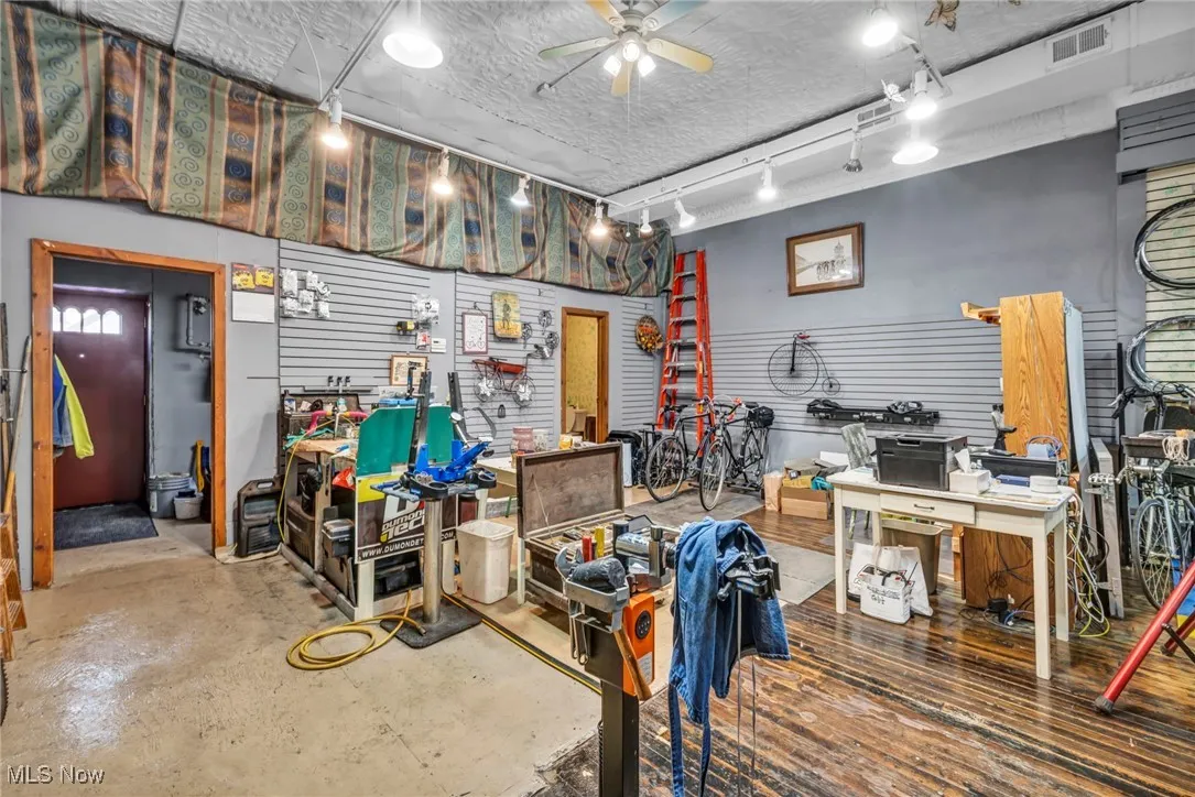 Workshop area with hardwood floors / back entrance/exit with utilities