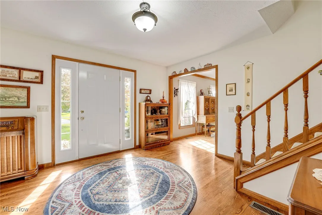 Foyer with beautiful hardwood flooring opens to the formal living room and dining room