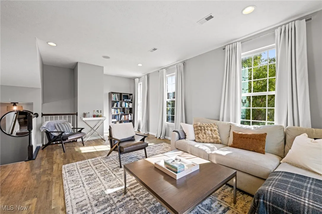 Living area featuring wood finished floors and recessed lighting