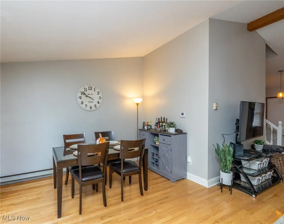 Dining area featuring light wood-style floors and a bar