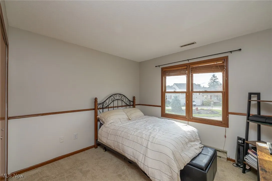 Bedroom featuring light carpet and a closet