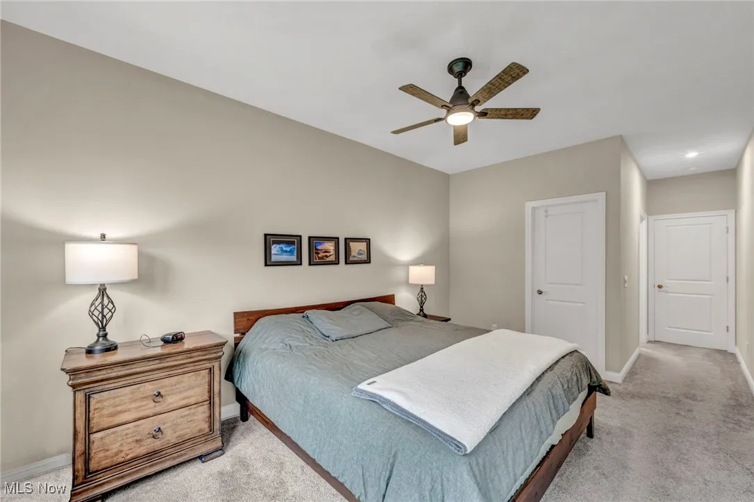 Bedroom with light carpet and ceiling fan