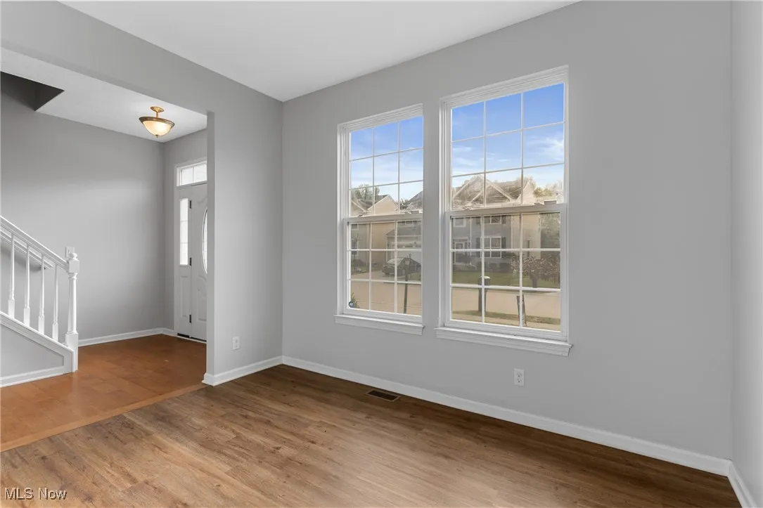 Foyer featuring light wood-type flooring and stairs