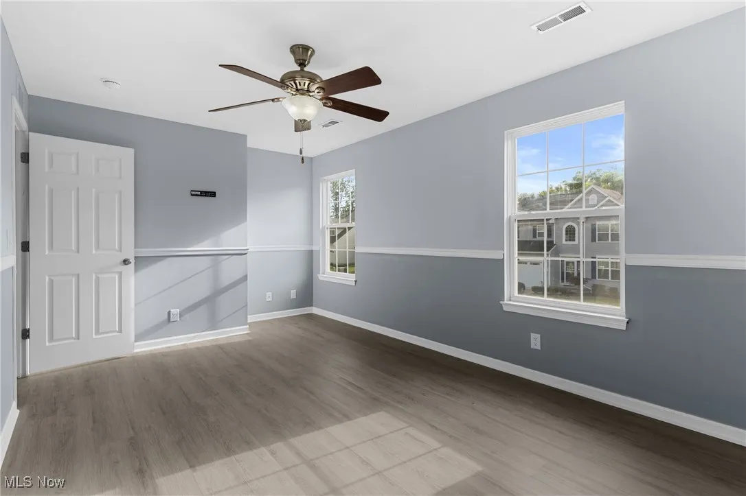 Unfurnished room featuring wood finished floors and a ceiling fan