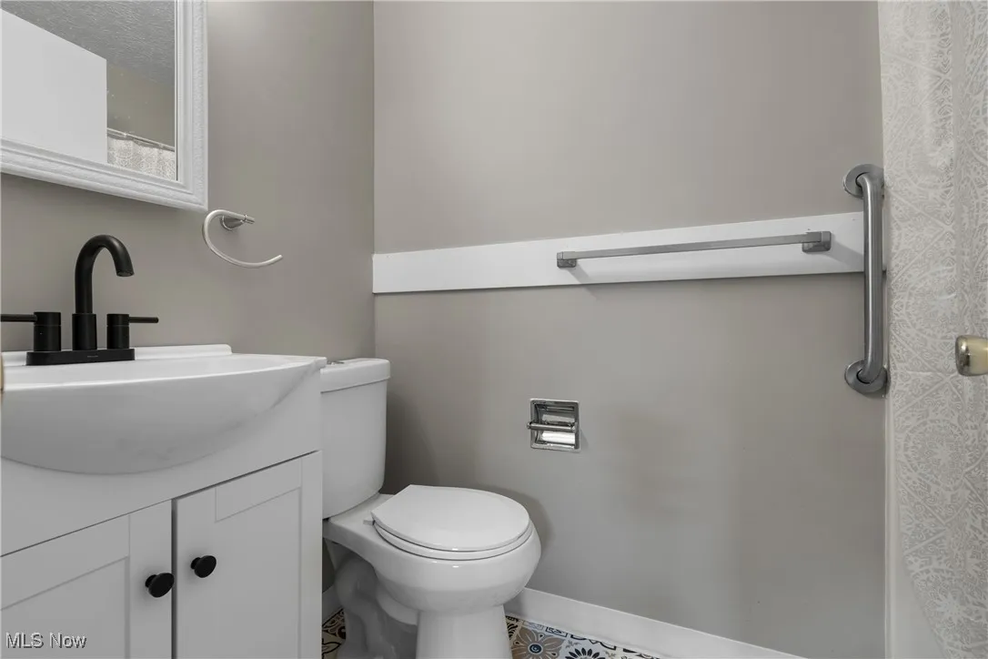 Full bathroom with vanity and toilet