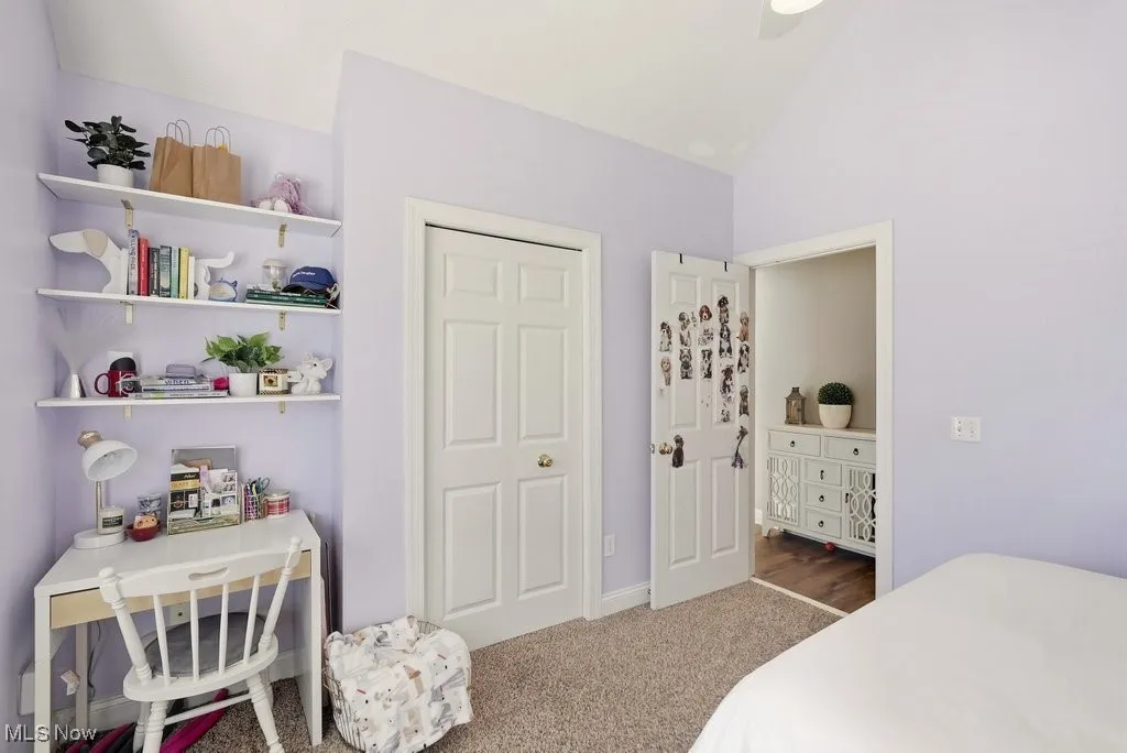 Bedroom with carpet flooring and lofted ceiling