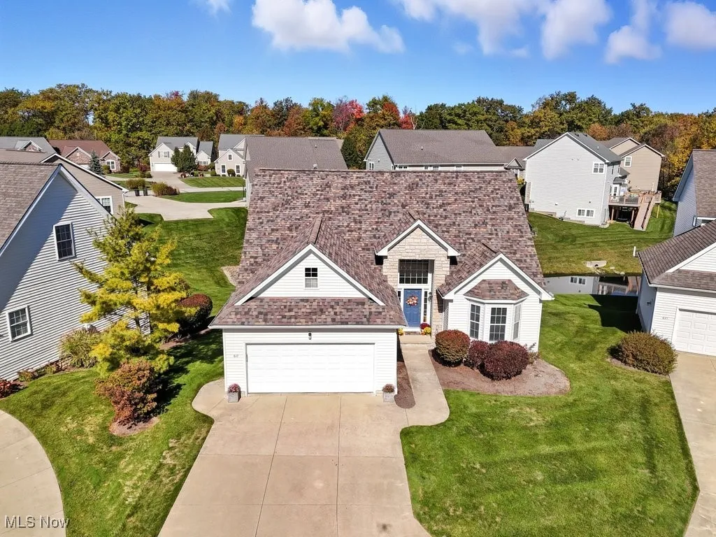 Traditional home with a residential view, concrete driveway, and a front yard