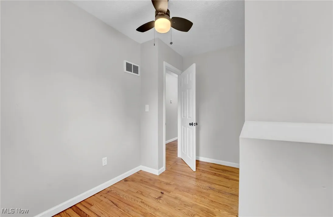 Unfurnished room with light wood-style floors and a ceiling fan