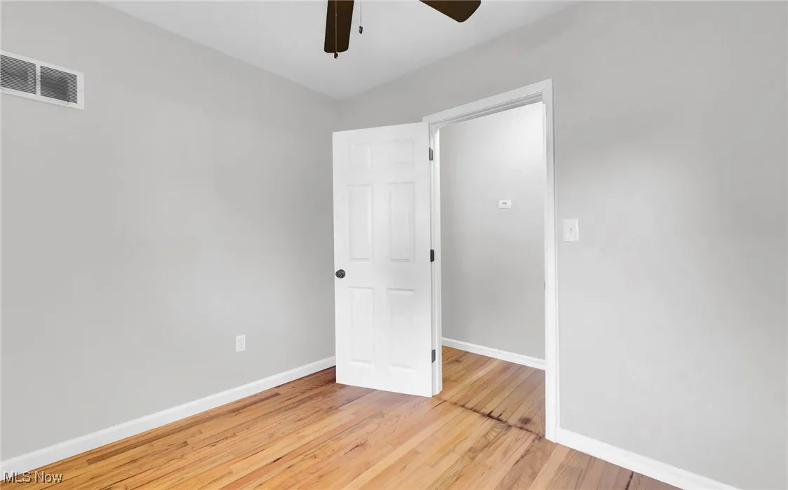 Unfurnished room featuring light wood-style floors and a ceiling fan
