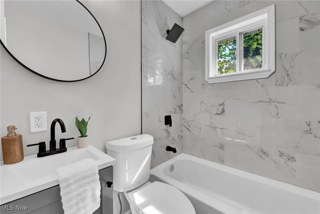 Full bathroom featuring shower / tub combination and vanity