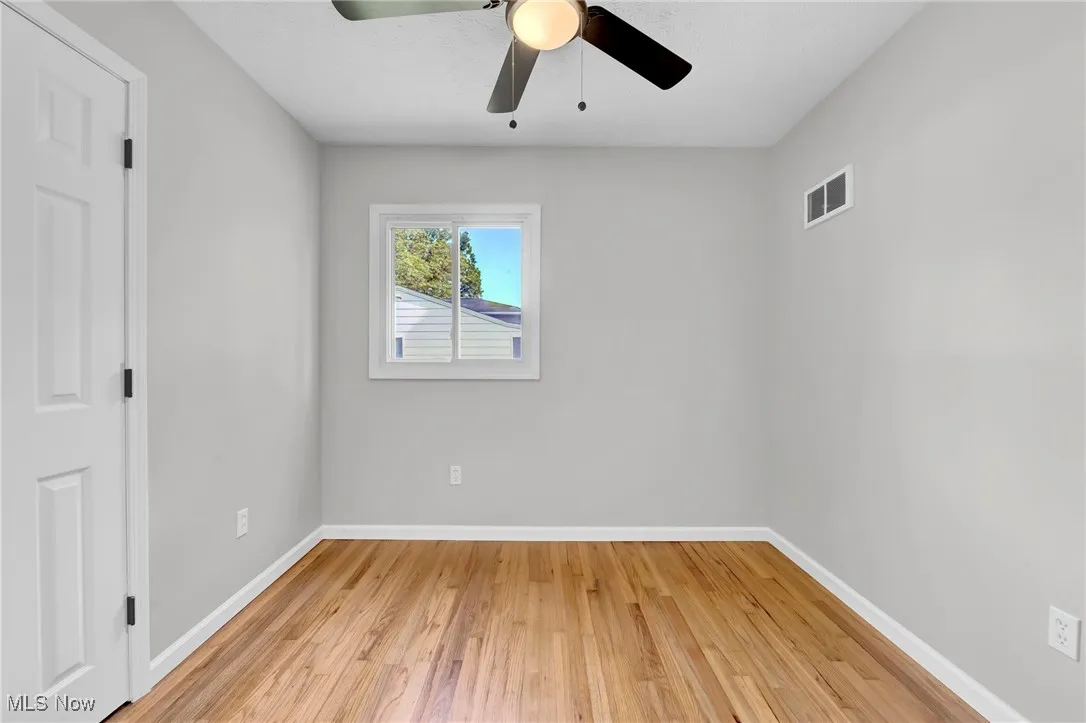 Spare room with light wood-style flooring and ceiling fan