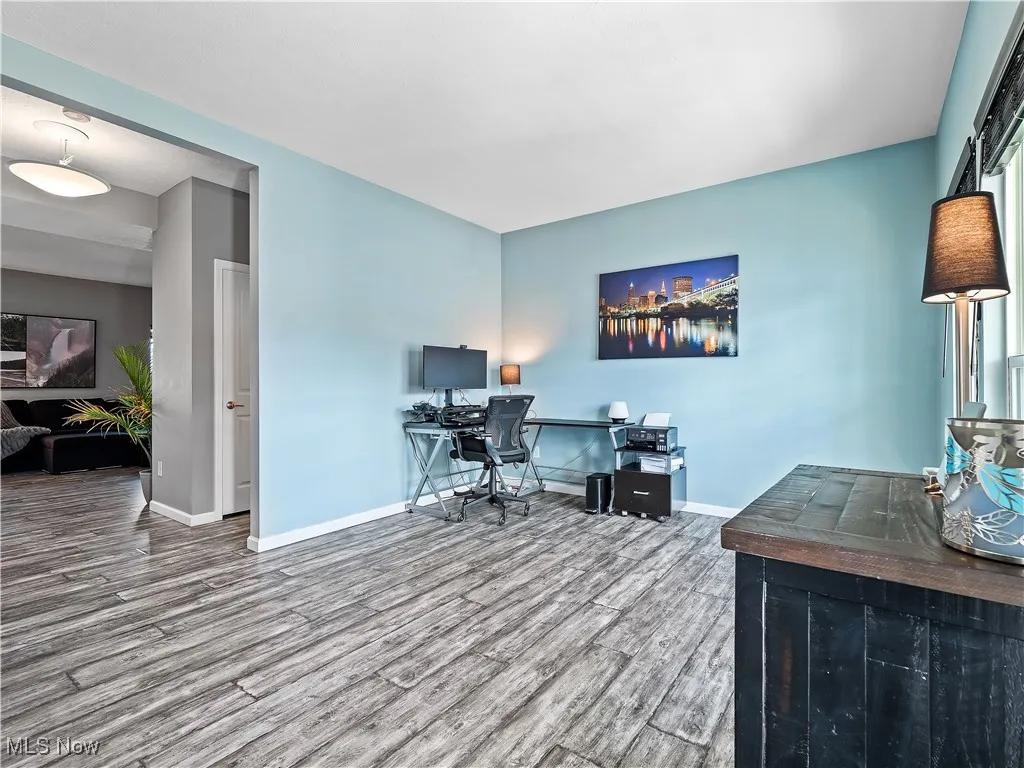 Office space featuring wood finished floors and baseboards