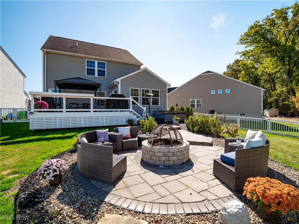 View of patio featuring an outdoor living space with a fire pit, a gazebo, and a wooden deck
