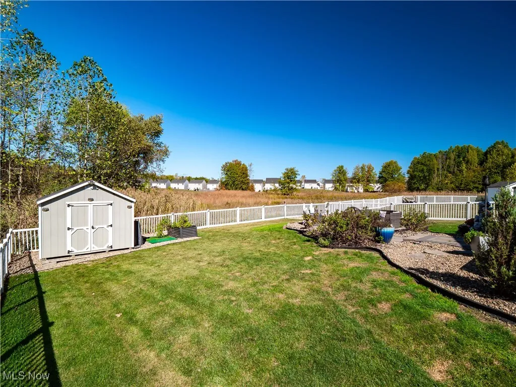Fenced backyard with a shed