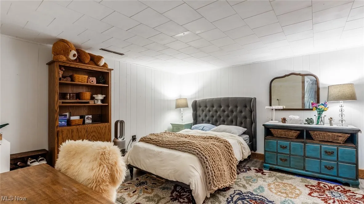 Lower Level Bedroom featuring wooden walls
