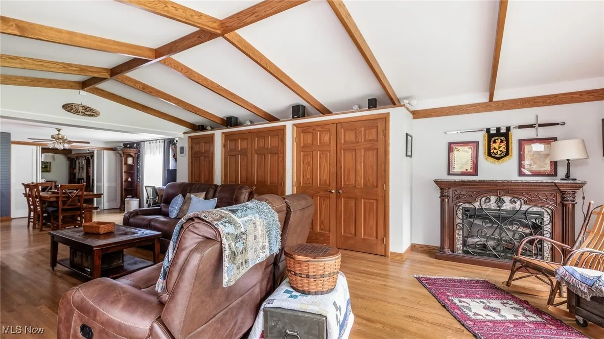 Living area with light wood finished floors and ceiling fan