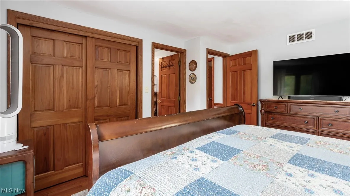 Bedroom with a closet and wood finished floors