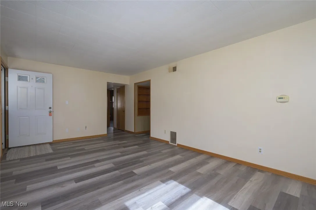 Spare room with wood finished floors and baseboards