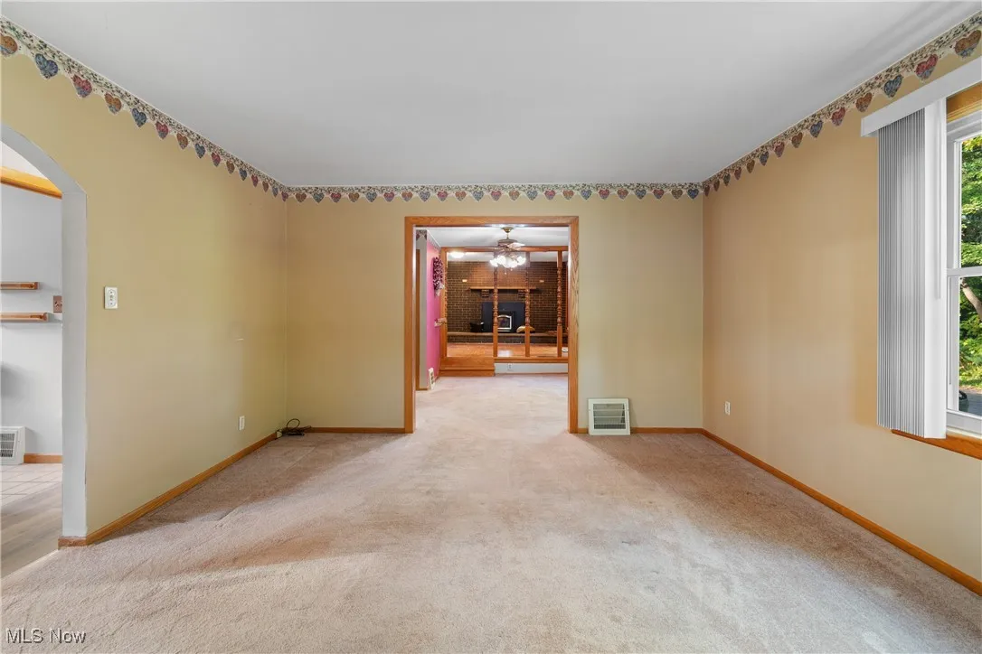 Spare room with arched walkways and carpet