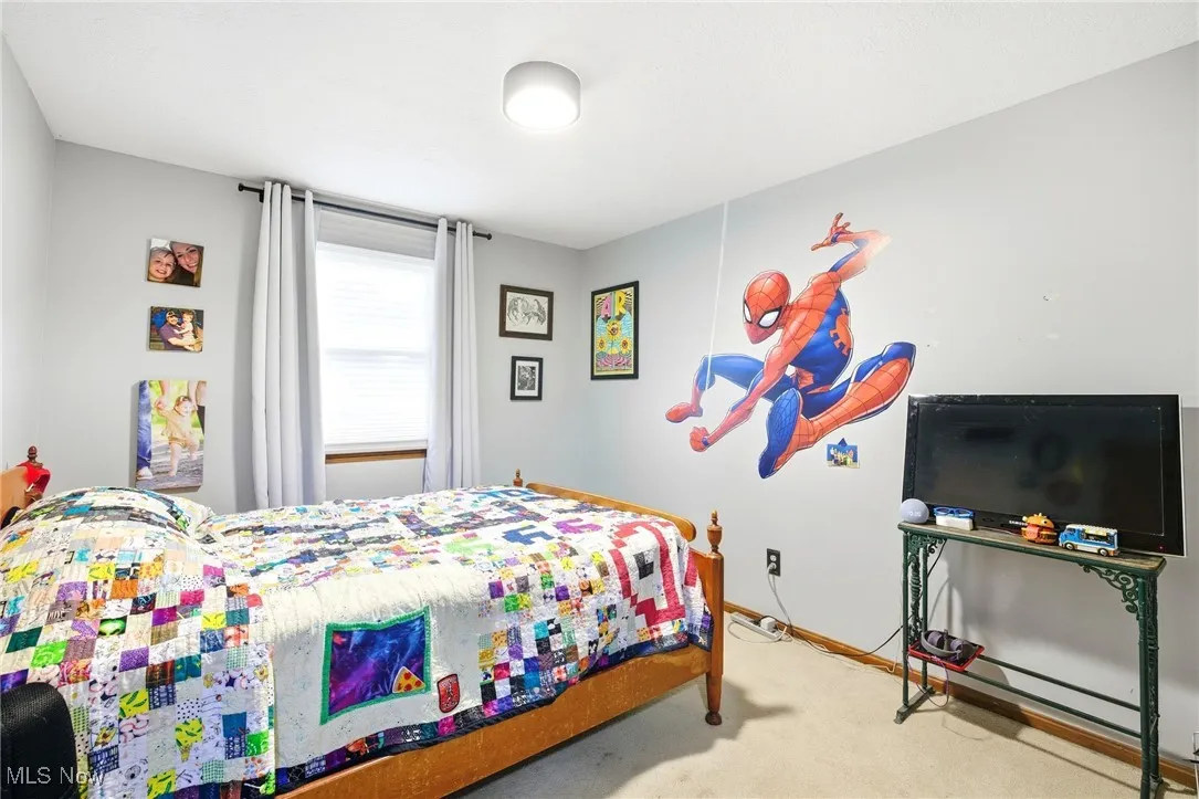 Bedroom featuring light colored carpet