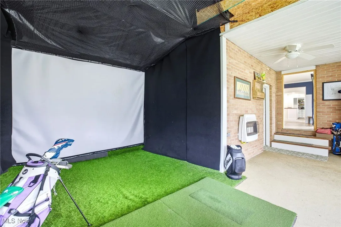 Sunroom area featuring the golf simulator/movie screen