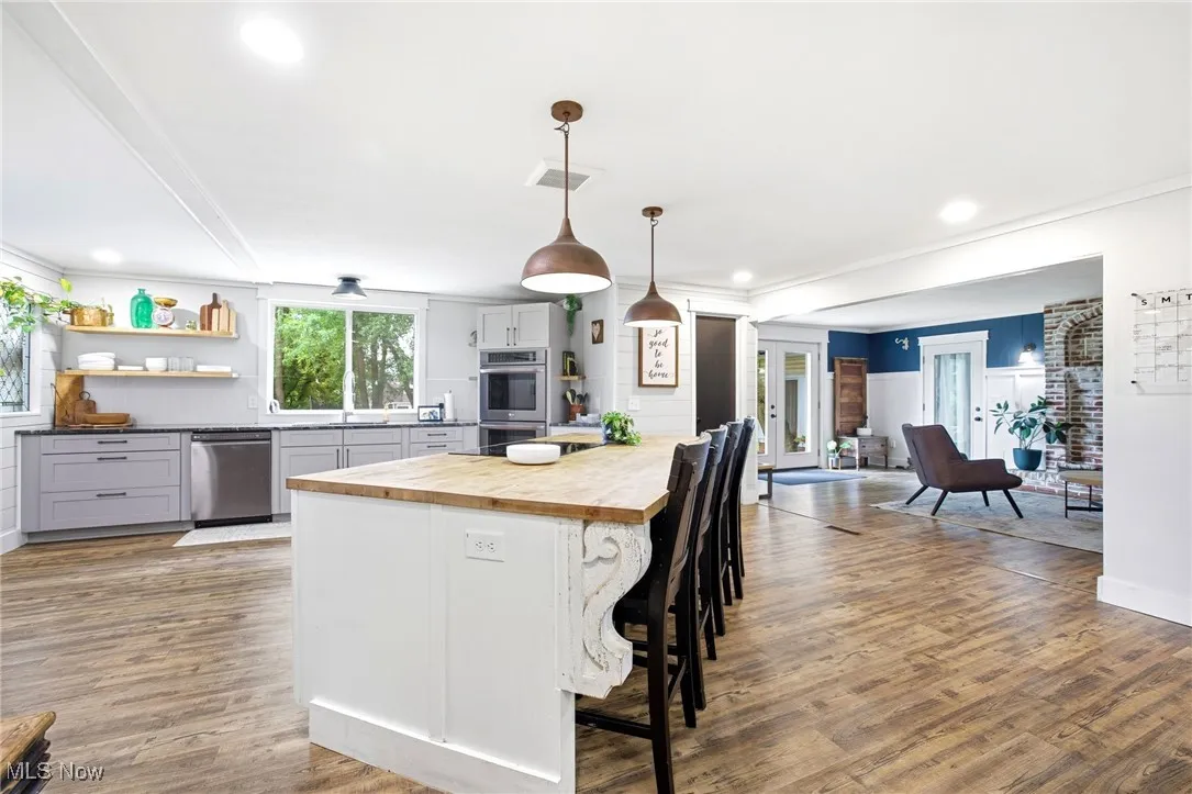 Kitchen featuring the island, cabinetry and appliances