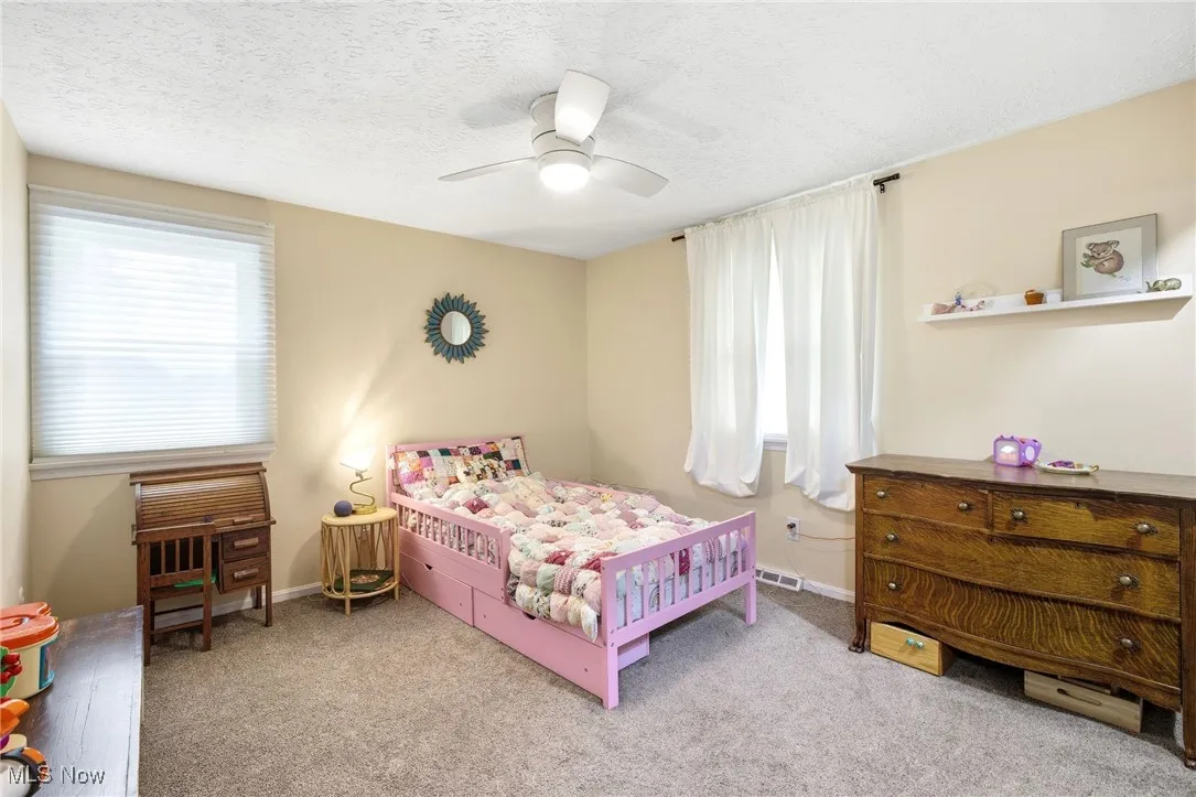 Bedroom featuring light colored carpet