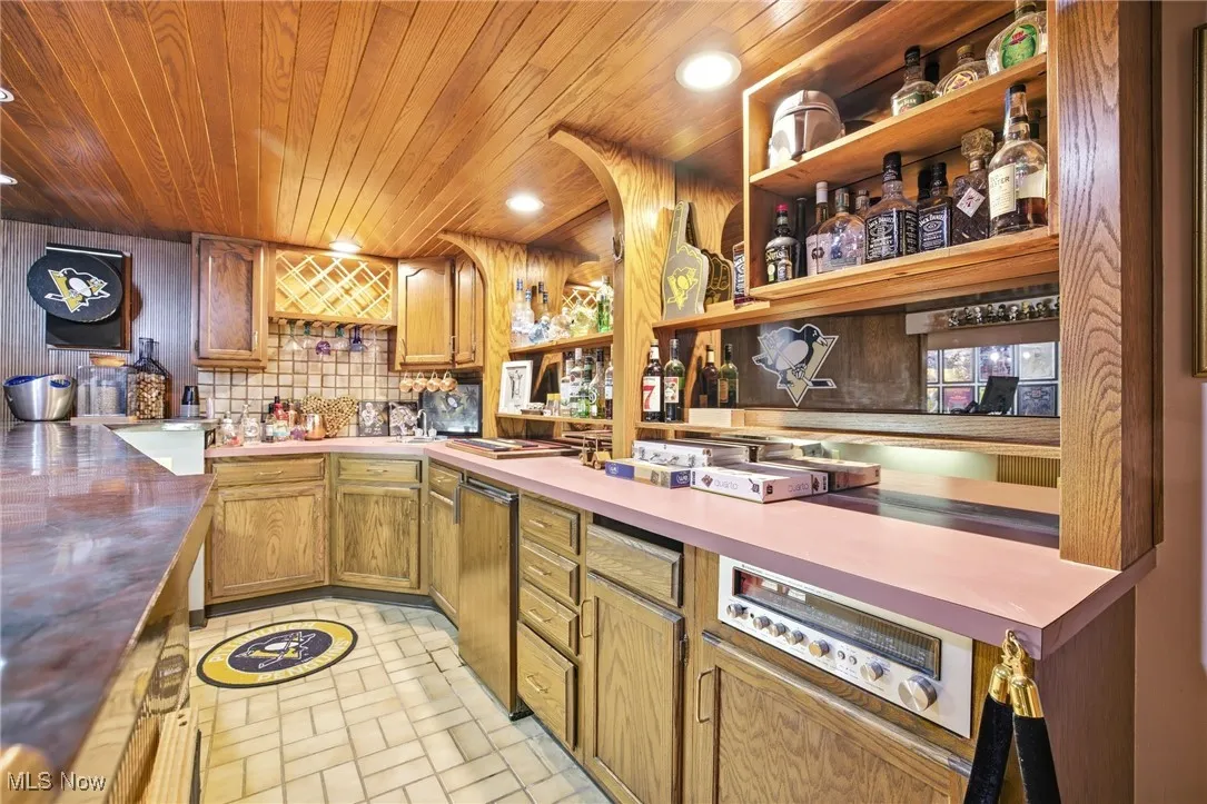 Bar featuring open shelves and cabinets
