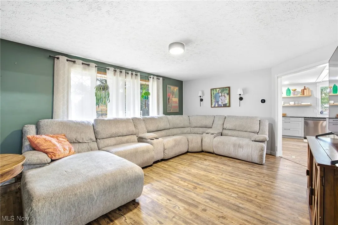 Living area featuring large window and LVT flooring
