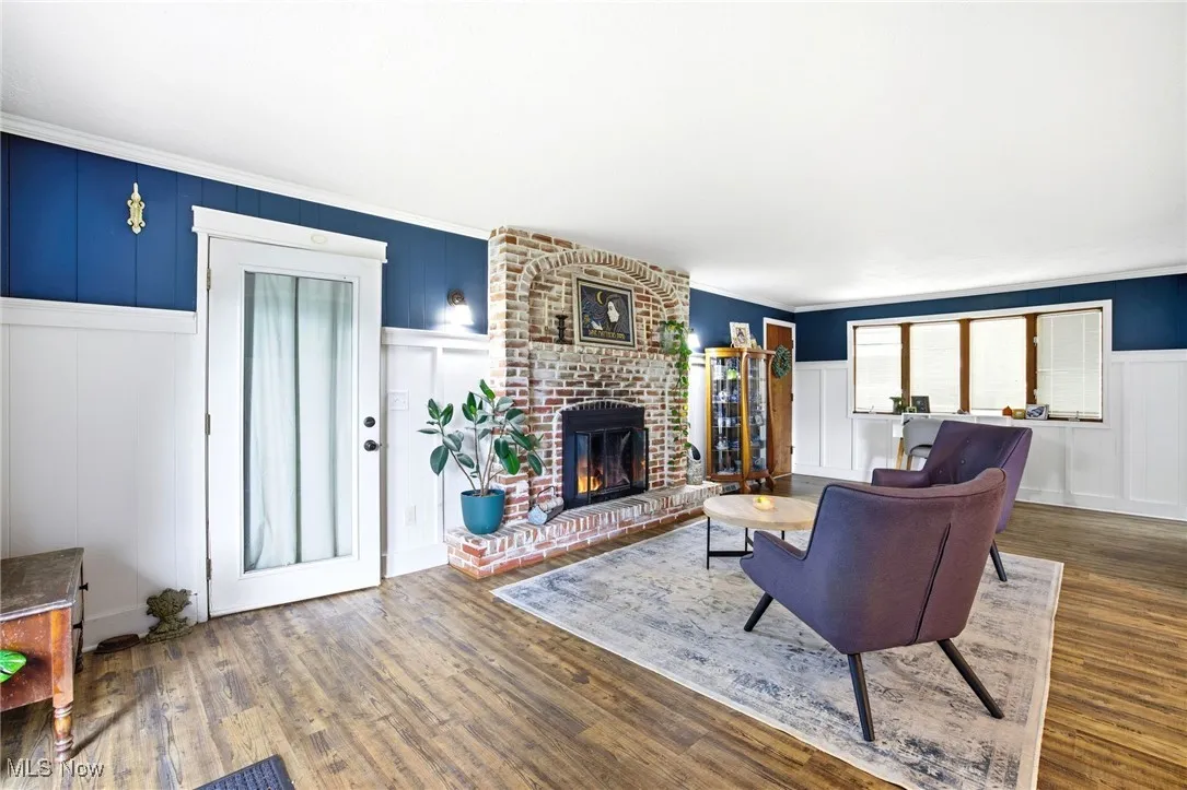 Family room area featuring the brick fireplace and LVT flooring