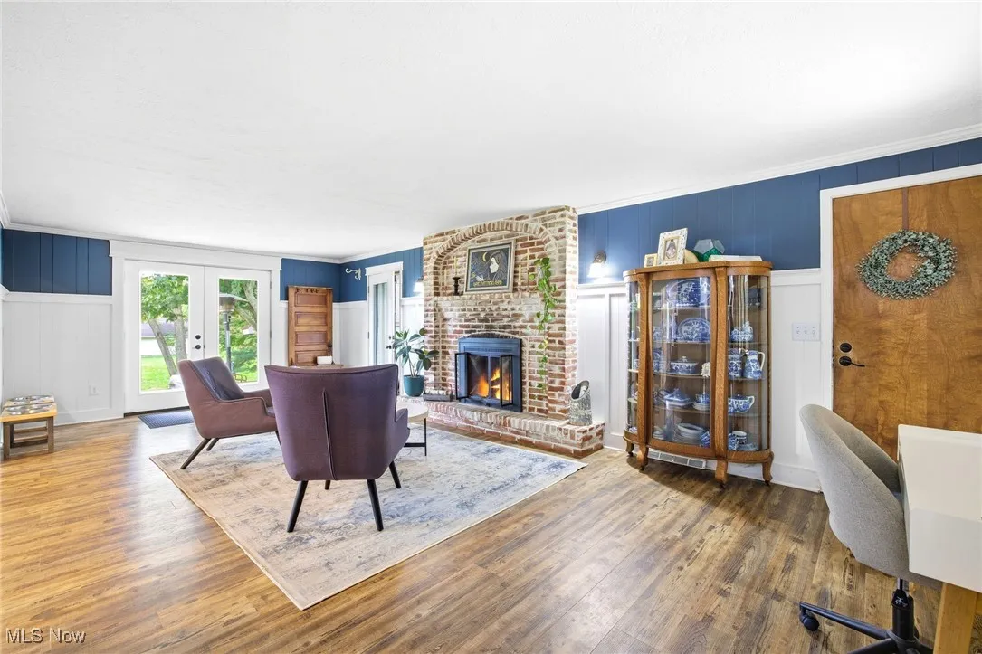 Family room featuring the fireplace, French doors, and LVT flooring