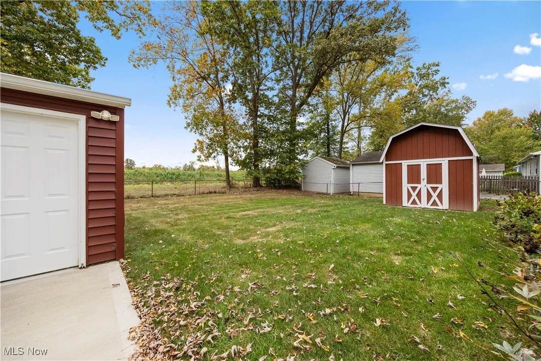 View from back bedroom of the home facing front of the garage and front of the storage shed