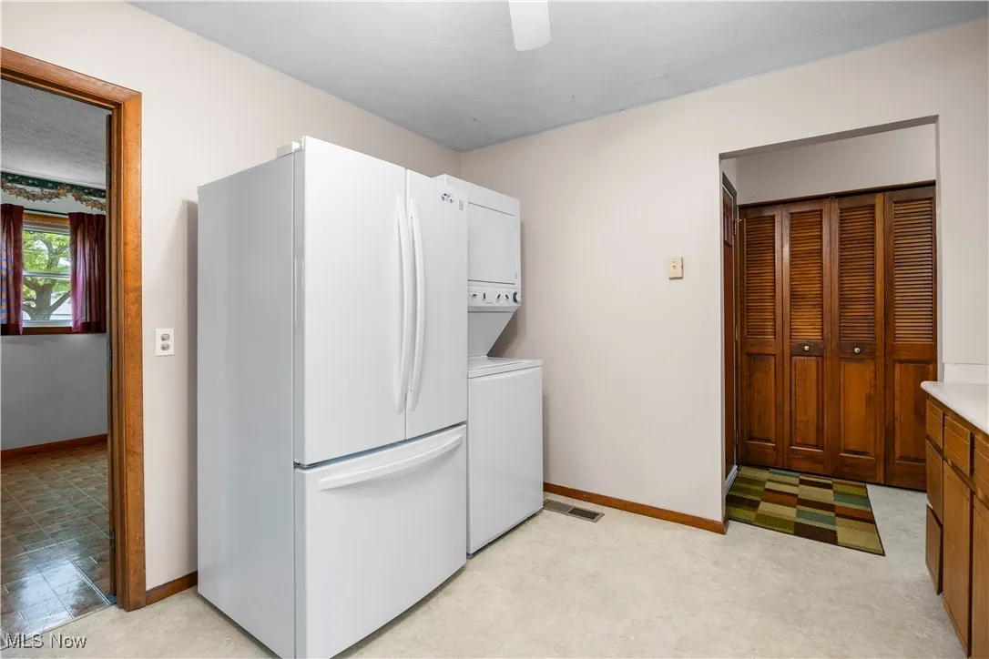View shows the in kitchen laundry as well as entrance to the foyer and entrance to large multi purpose room