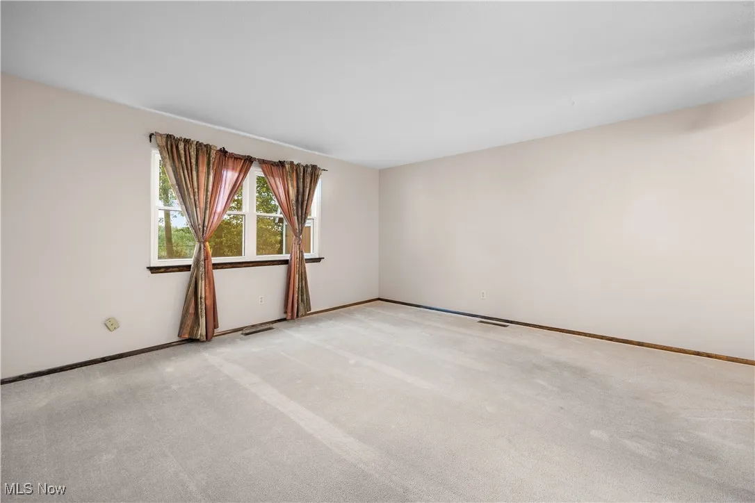 living room facing back of the home from hall way area