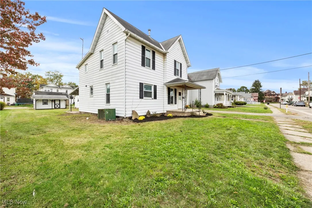 View of side of property with a yard