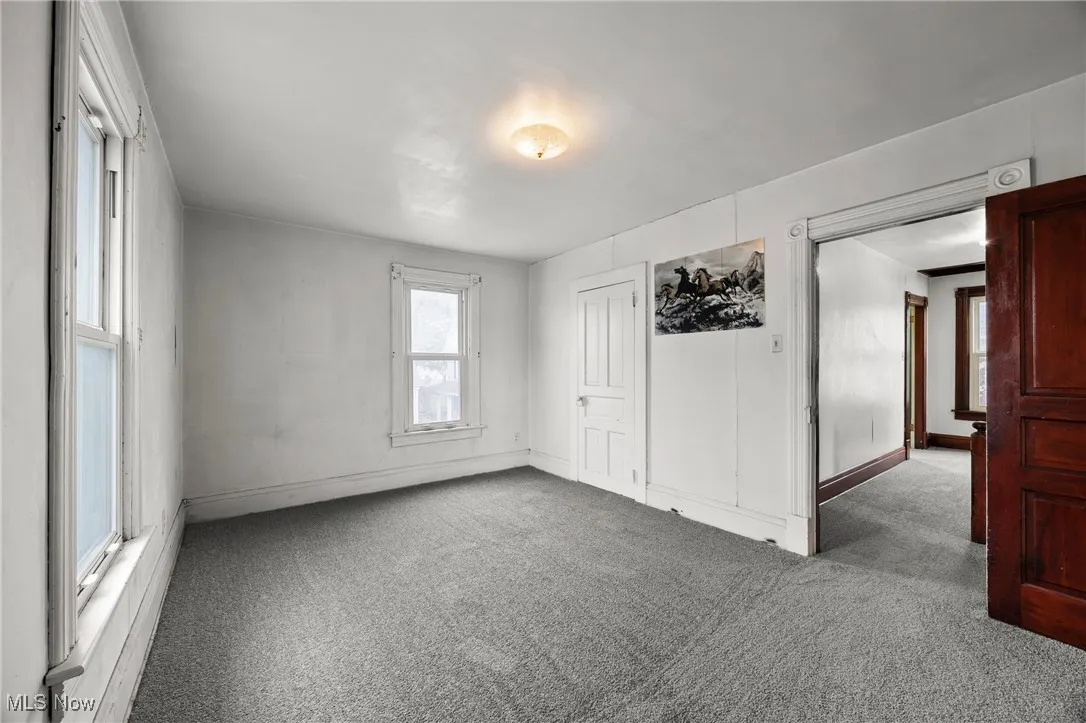 Unfurnished bedroom with carpet and baseboards